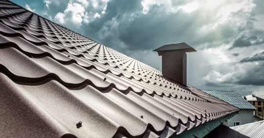 Metal roof under bright sunlight with some storm clouds