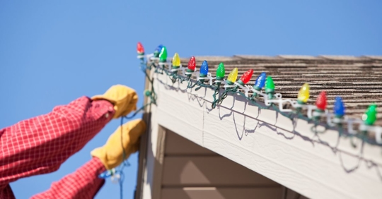 putting up holiday lights