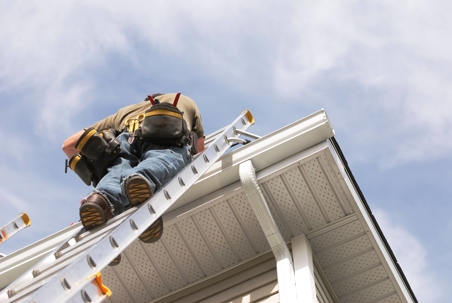 roofer on ladder working on home repairs